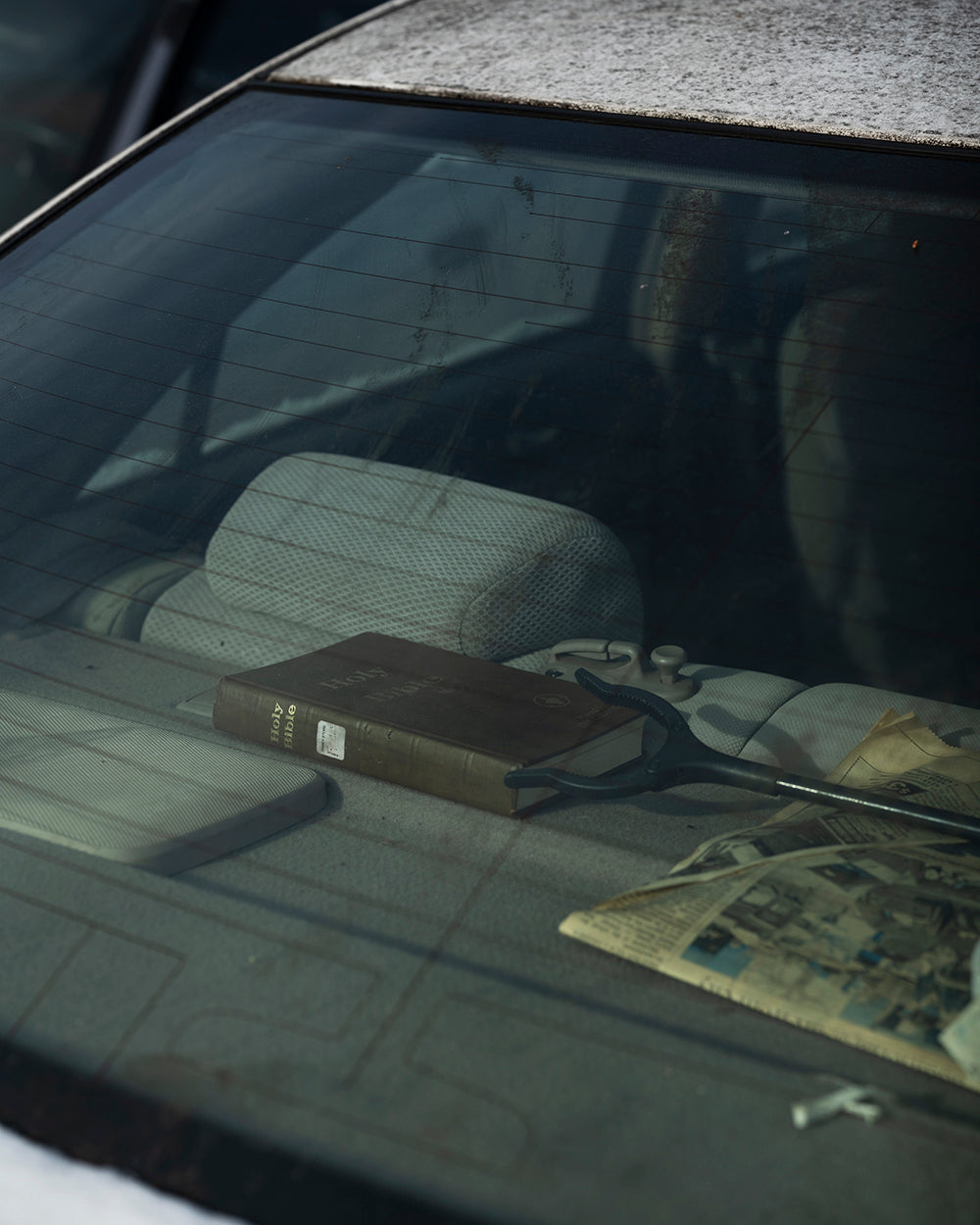Photography by Nick Meyer titled "Backseat Bible" - 2.